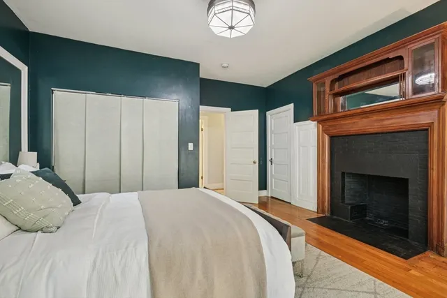 a bedroom with a bed and a fireplace