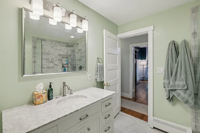 a bathroom with a granite countertop sink and a mirror