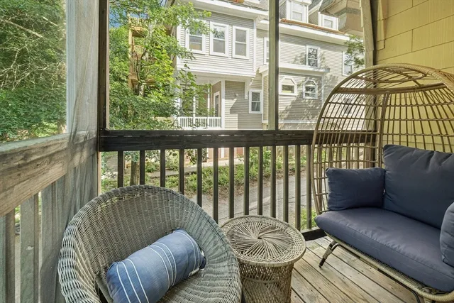 a view of a house with a small yard plants and large tree