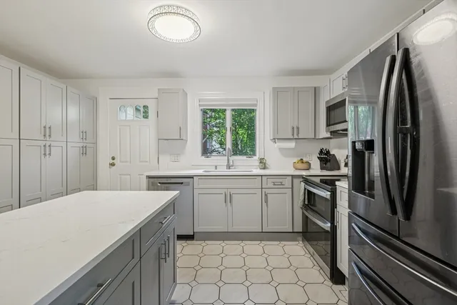 a kitchen with a refrigerator sink and stove