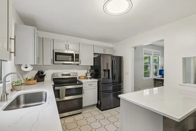 a kitchen with a sink cabinets and stainless steel appliances