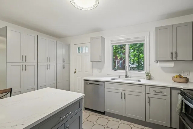 a kitchen with a sink cabinets and wooden floor