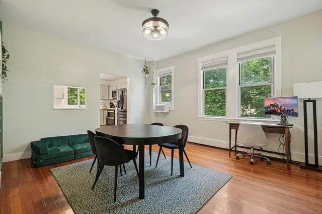 a view of a dining room with furniture window and wooden floor