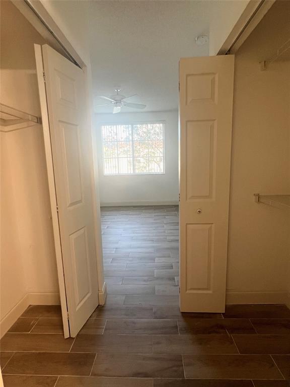 8060 North Nob Hill Road, Unit 206 Tamarac, FL 33321 - Photo 13 of 16 an empty room with wooden floor and windows