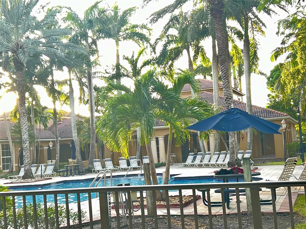 8060 North Nob Hill Road, Unit 206 Tamarac, FL 33321 - Photo 15 of 16 a view of a patio with furniture and wooden floor