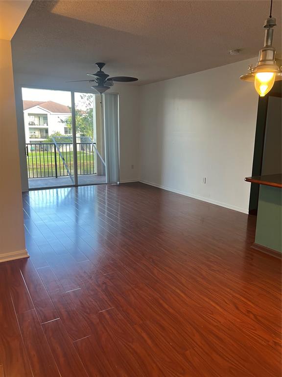 8060 North Nob Hill Road, Unit 206 Tamarac, FL 33321 - Photo 3 of 16 a view of empty room with wooden floor and fan