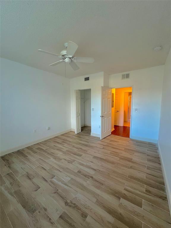 8060 North Nob Hill Road, Unit 206 Tamarac, FL 33321 - Photo 9 of 16 an empty room with a window and ceiling fan