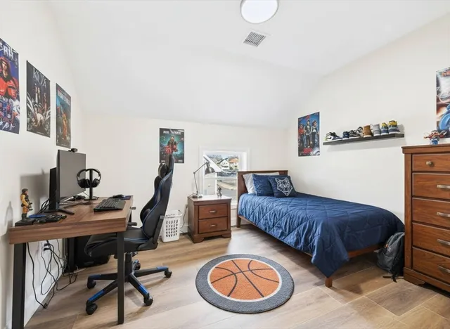 a bedroom with a bed and a desk