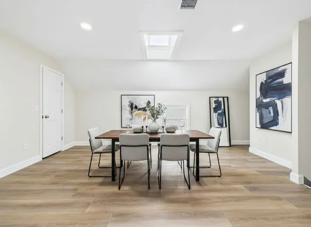 a dining room with furniture and window