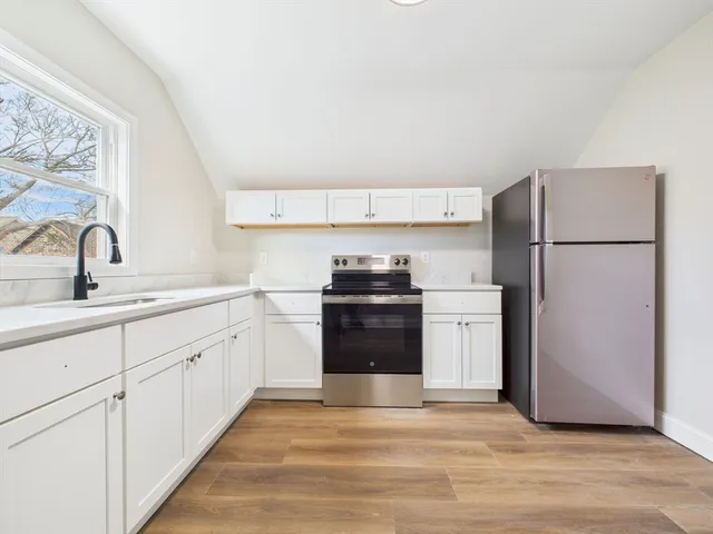 a kitchen with a sink and a refrigerator