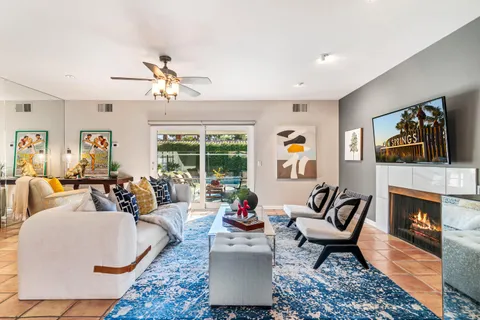 a living room with furniture fireplace and window