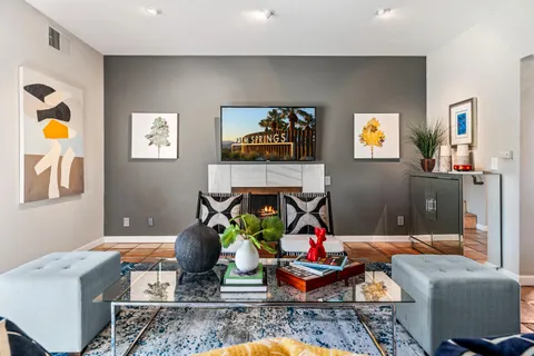 a living room with furniture and painting on the wall