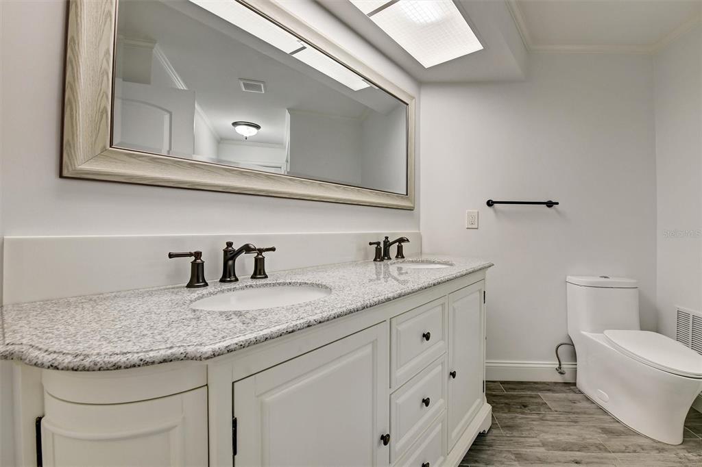 1875 Belleair Road Clearwater, FL 33764 - Photo 48 of 100 a bathroom with a granite countertop sink and a mirror