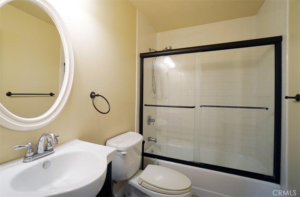 14722 Comet Street Irvine, CA 92604 - Photo 14 of 22 a bathroom with a sink mirror vanity and toilet