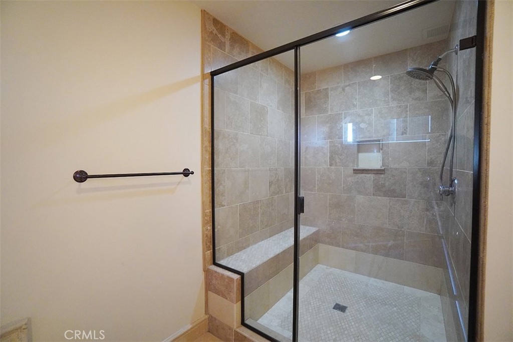 14722 Comet Street Irvine, CA 92604 - Photo 21 of 22 a bathroom with a glass shower door
