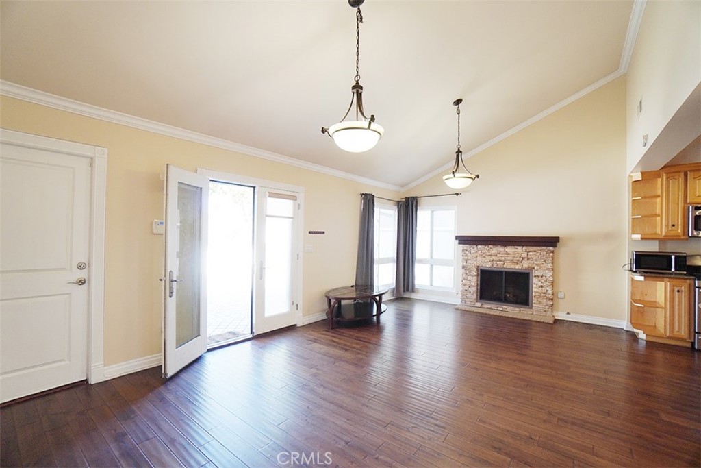 14722 Comet Street Irvine, CA 92604 - Photo 6 of 22 a view of empty room with fireplace and wooden floor