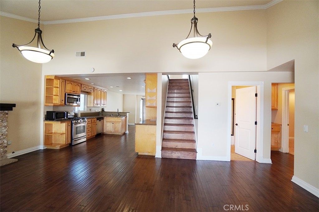 14722 Comet Street Irvine, CA 92604 - Photo 7 of 22 a view of a kitchen with stove and wooden floor