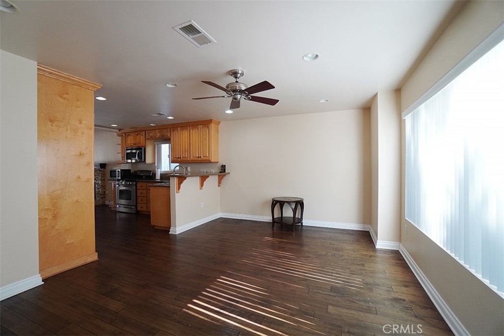 14722 Comet Street Irvine, CA 92604 - Photo 8 of 22 a view of kitchen with cabinets and wooden floor