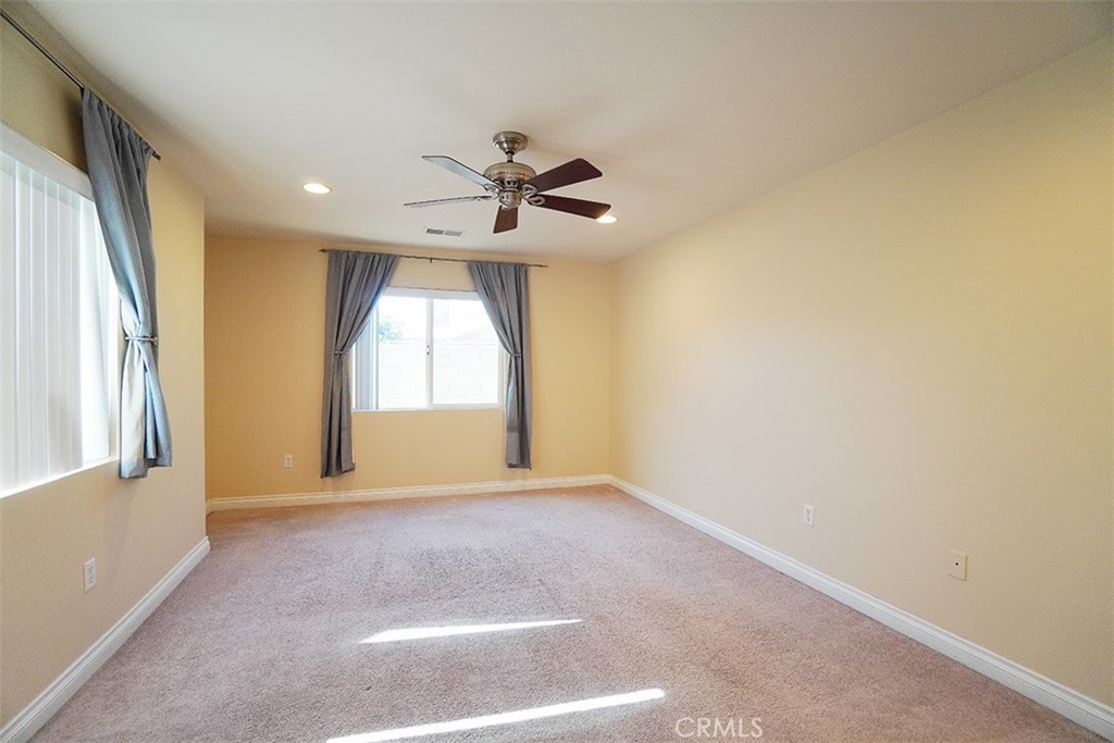 14722 Comet Street Irvine, CA 92604 - Photo 9 of 22 a view of a livingroom with a chandelier fan and windows