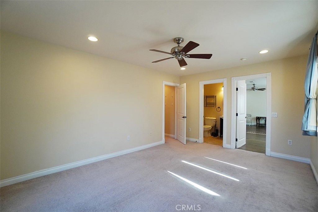 14722 Comet Street Irvine, CA 92604 - Photo 10 of 22 en empty room with a ceiling fan and a window