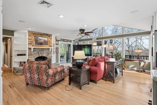 a kitchen with stainless steel appliances granite countertop a refrigerator a stove a sink and white cabinets