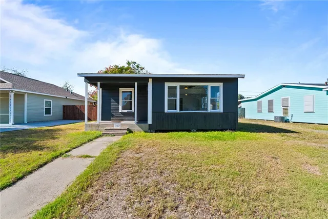 a view of a house with swimming pool and a yard