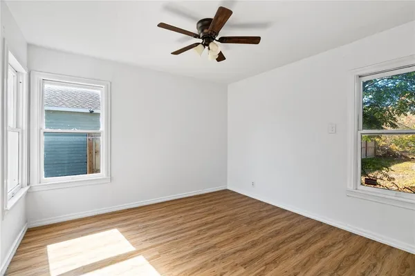 a view of a room with wooden floor and a window