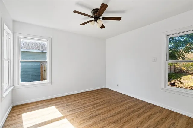 a view of a room with wooden floor and a window