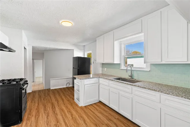 a kitchen with a sink window and cabinets