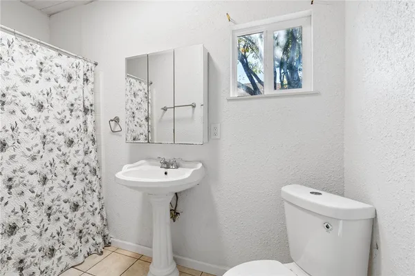 a bathroom with a sink mirror and toilet