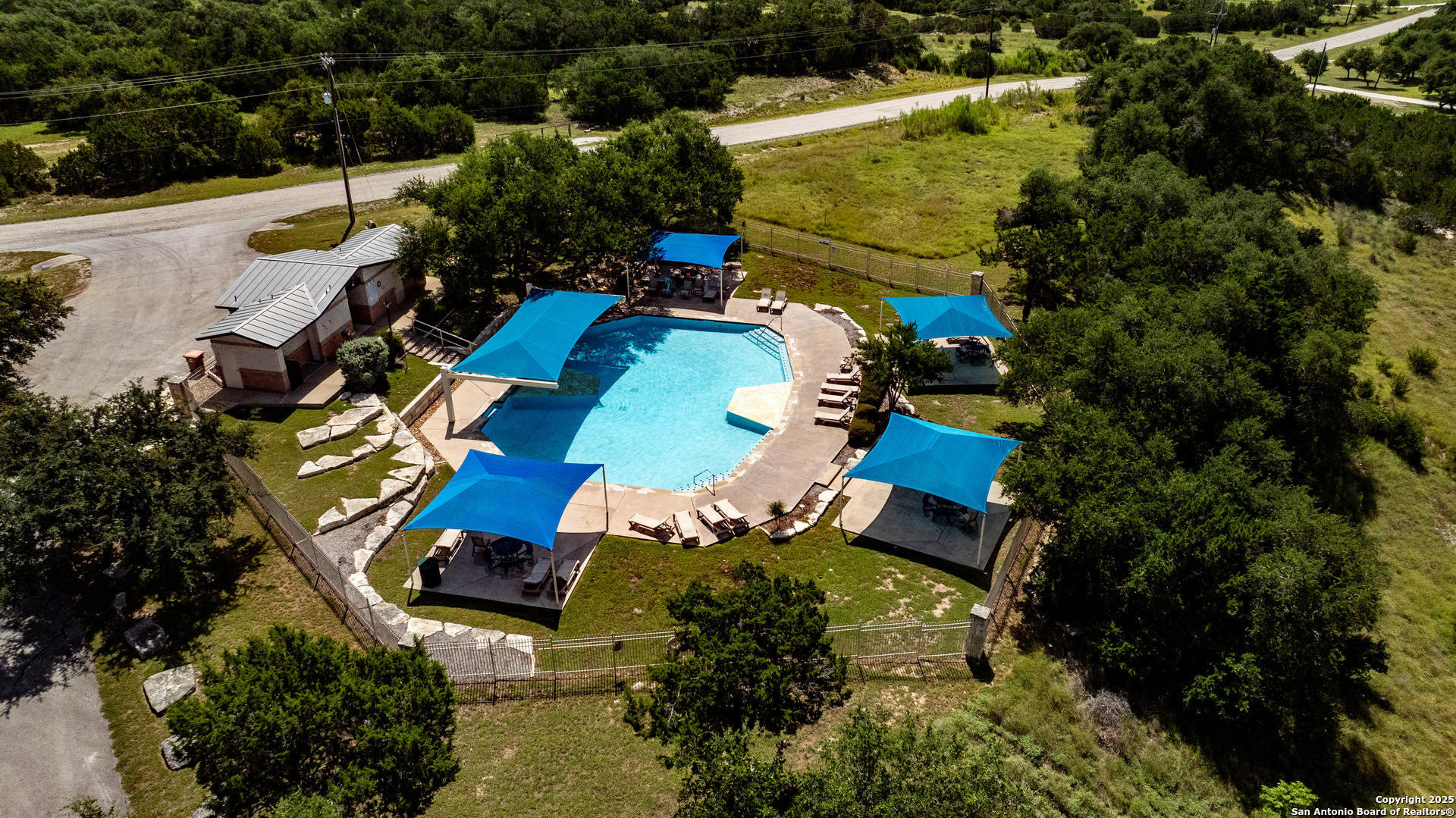 525 Rock Trail Place Spring Branch, TX 78070 - Photo 14 of 22 an aerial view of a house with a garden and swimming pool