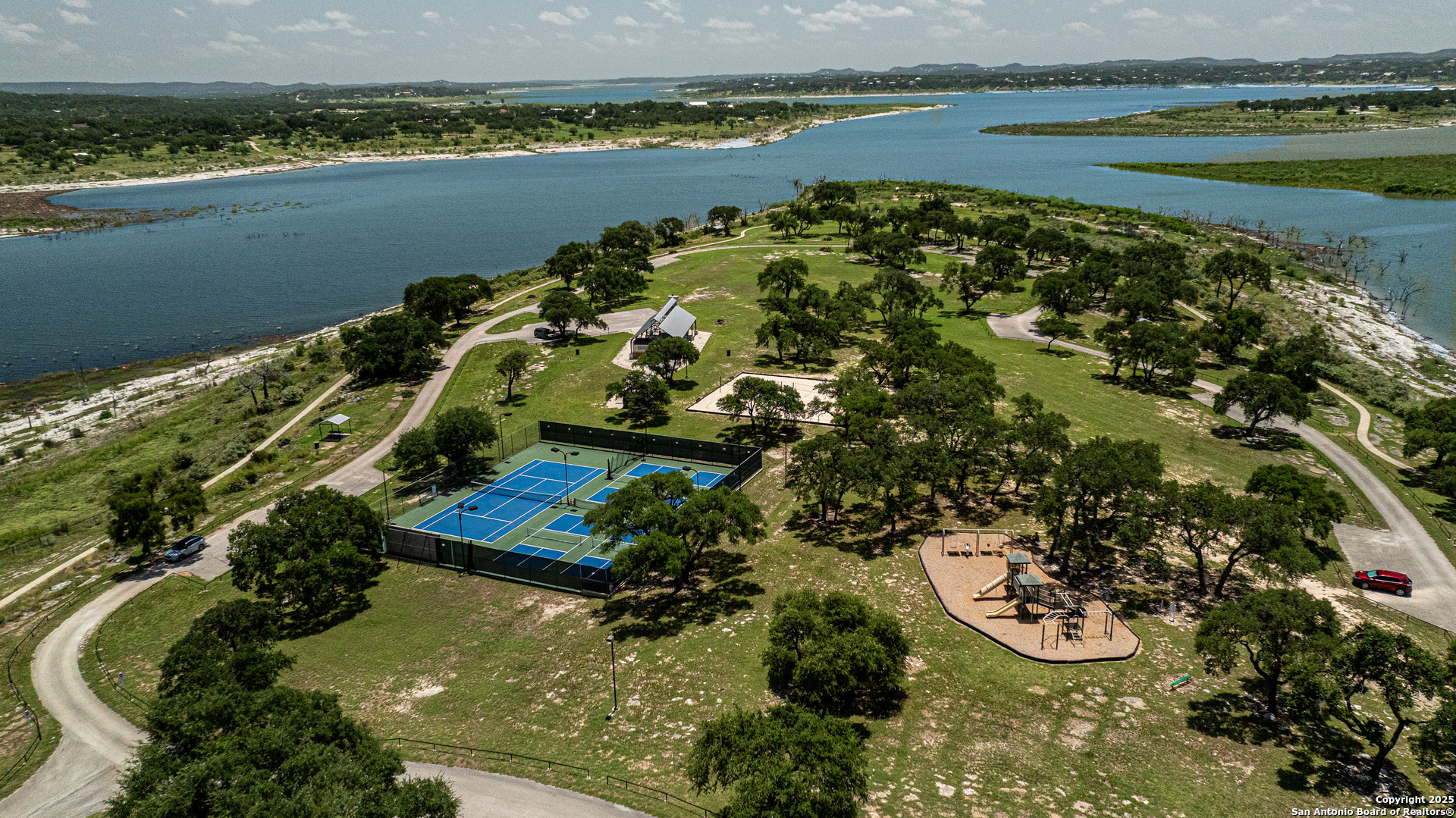 525 Rock Trail Place Spring Branch, TX 78070 - Photo 19 of 22 a view of a lake with lawn chairs