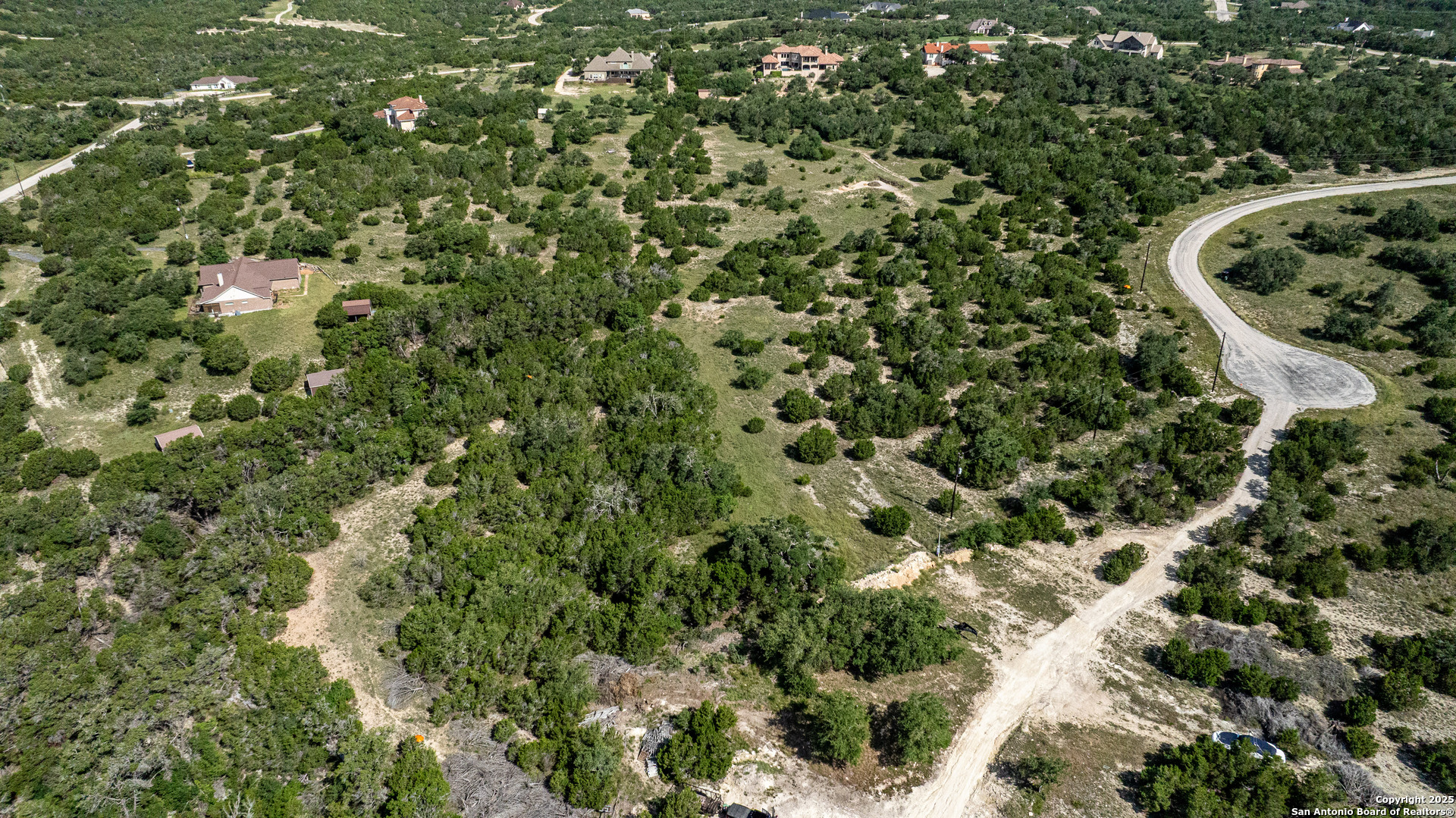 525 Rock Trail Place Spring Branch, TX 78070 - Photo 2 of 22 a view of a forest with a house