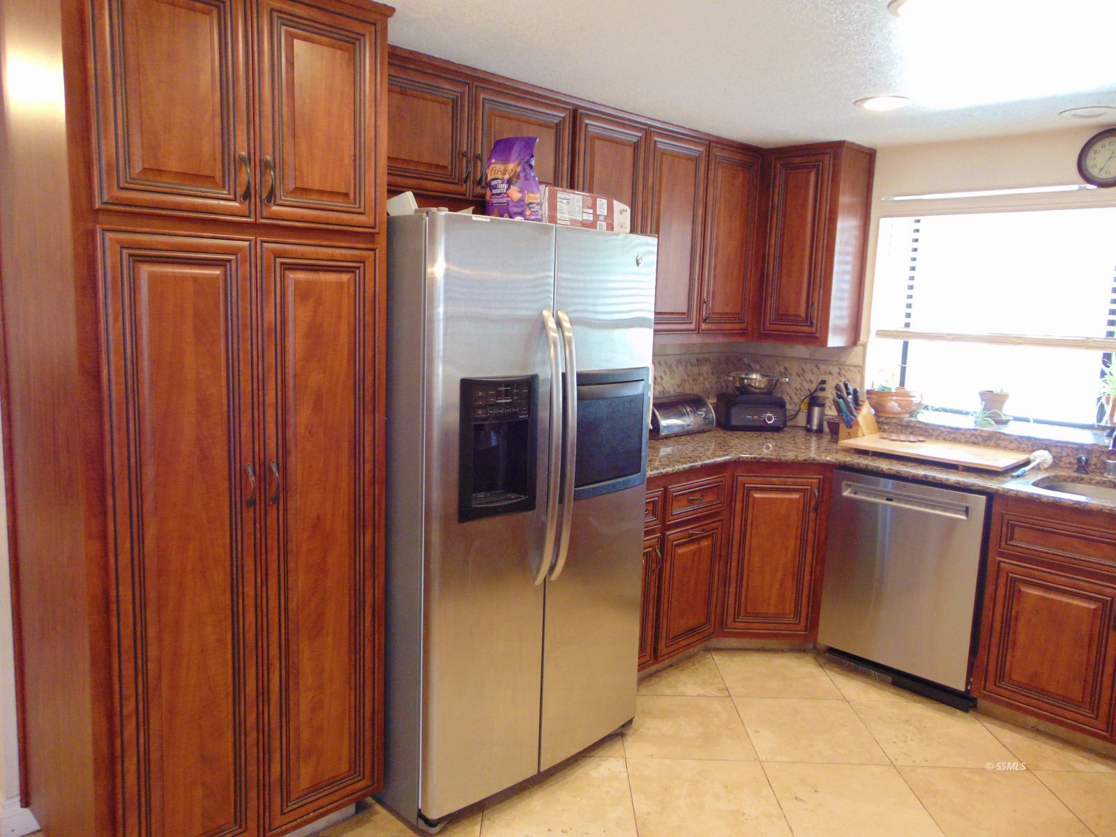 917 Carolyn Street Ridgecrest, CA 93555 - Photo 10 of 26 a kitchen with stainless steel appliances granite countertop a refrigerator and cabinets