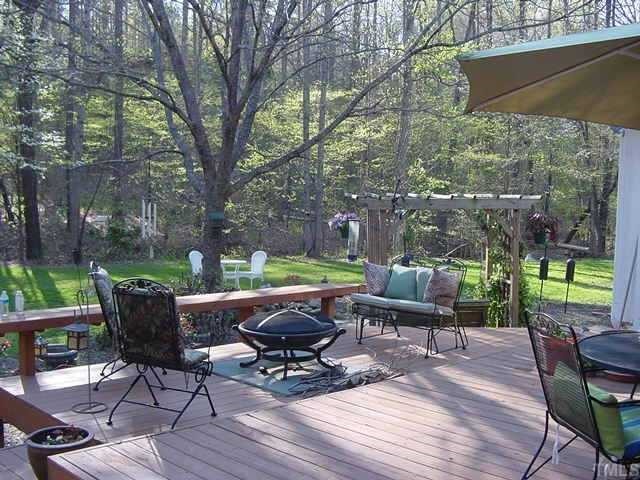 11612 Appaloosa Run West Raleigh, NC 27613 - Photo 7 of 12 a view of a lounge chairs in back yard of the house