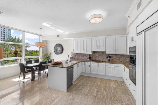 a living room with furniture and kitchen view