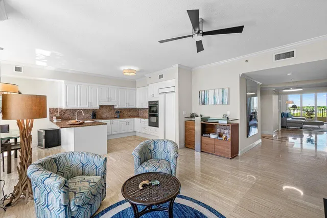 a kitchen with granite countertop a refrigerator and a stove top oven