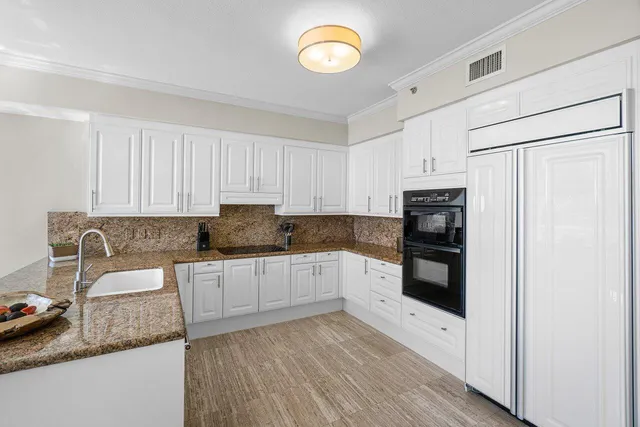 a dining room with furniture a potted plant and a chandelier