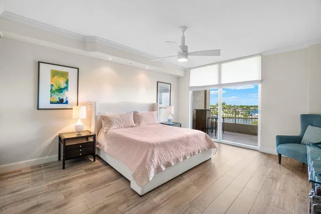 a spacious bedroom with a bed and a painting on the wall