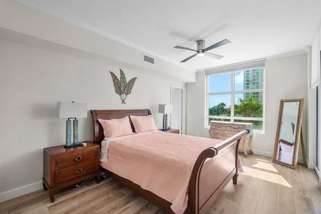 a bedroom with furniture and a large window