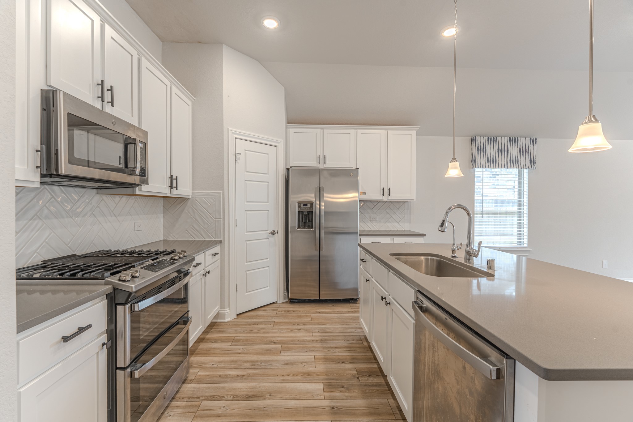 9840 Sweet Flag Court Conroe, TX 77385 - Photo 14 of 50 Chef-inspired kitchen includes all appliances and plenty of prep space, making it ideal for hosting, meal prep, or casual dining with family and friends.