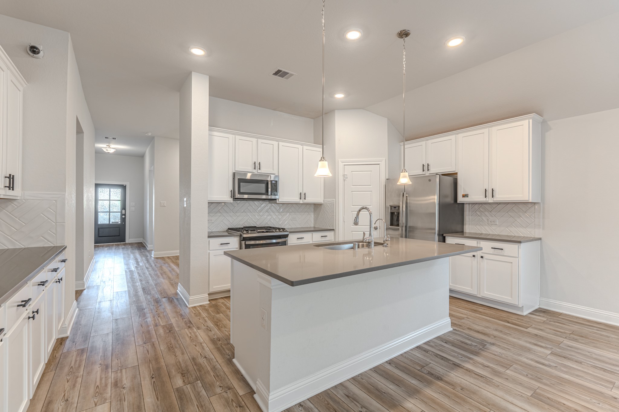 9840 Sweet Flag Court Conroe, TX 77385 - Photo 15 of 50 Oversized island serves as the heart of the home—perfect for entertaining guests, serving meals, or enjoying morning coffee in a stylish setting.