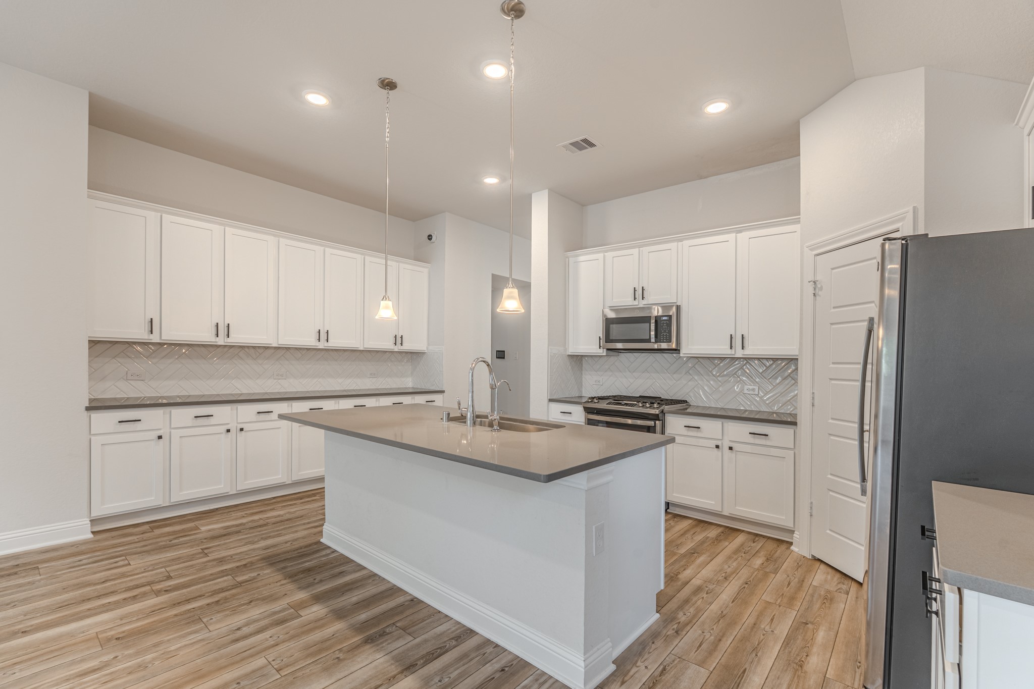 9840 Sweet Flag Court Conroe, TX 77385 - Photo 17 of 50 Kitchen and living areas are perfectly positioned to keep everyone connected while hosting or spending time together.