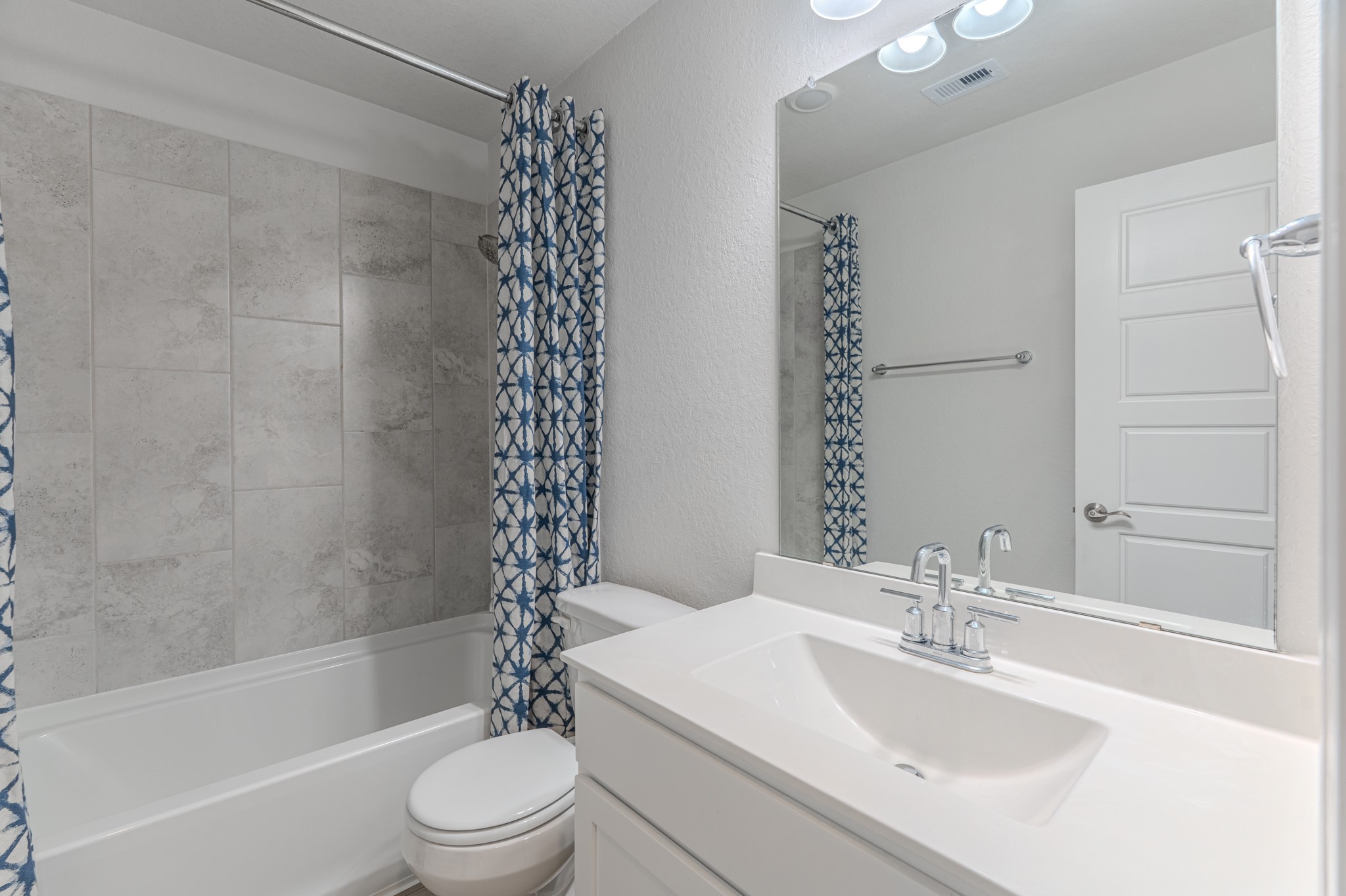 9840 Sweet Flag Court Conroe, TX 77385 - Photo 38 of 50 Secondary bathroom features a clean, modern design with a tub/shower combination, stylish finishes, and convenient access for guests or secondary bedrooms—both functional and inviting.