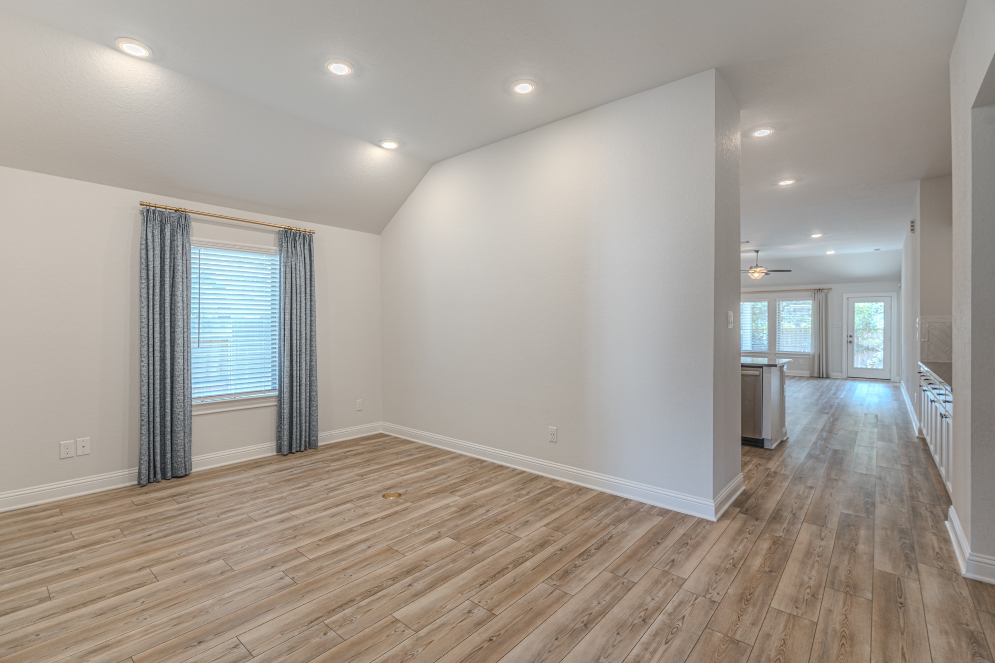 9840 Sweet Flag Court Conroe, TX 77385 - Photo 10 of 50 Light-filled living area offers a bright and inviting atmosphere, perfect for gatherings, movie nights, or relaxing after a long day in your new home.