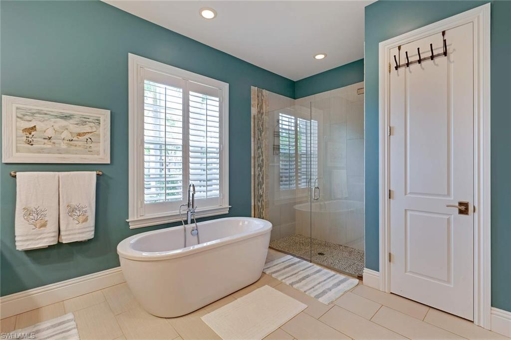 150 Central Avenue Naples, FL 34102 - Photo 13 of 35 a spacious bathroom with a bathtub and shower