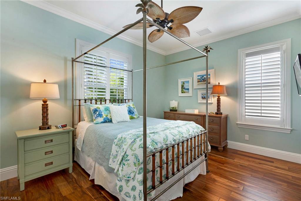 150 Central Avenue Naples, FL 34102 - Photo 14 of 35 a bedroom with a bed and a window