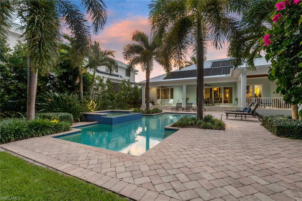 150 Central Avenue Naples, FL 34102 - Photo 25 of 35 a view of a house with swimming pool and sitting area