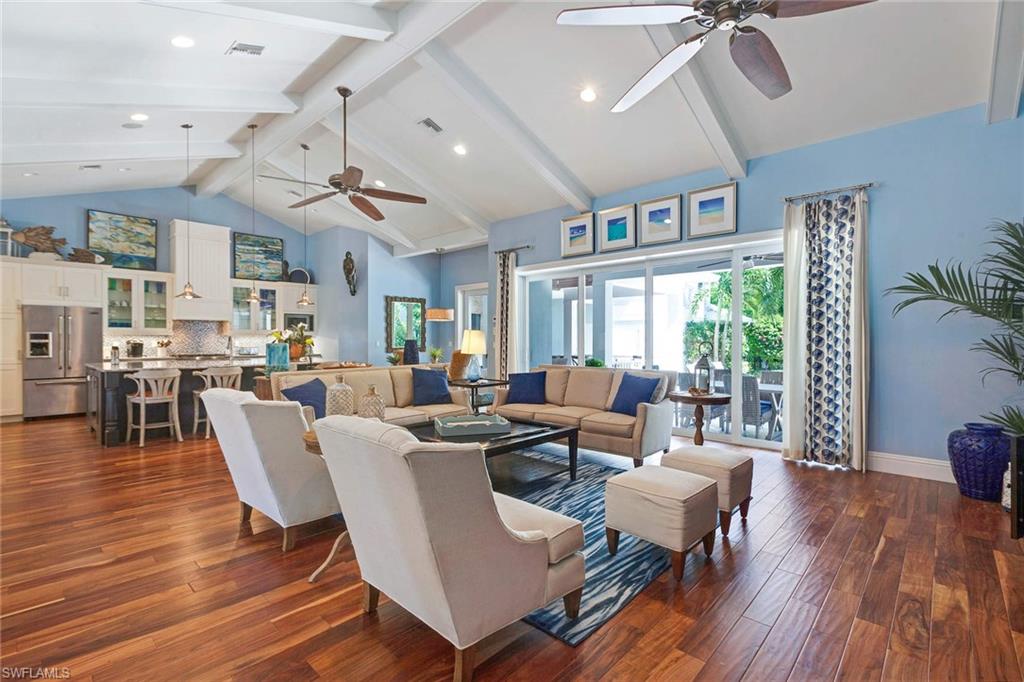 150 Central Avenue Naples, FL 34102 - Photo 3 of 35 a living room with lots of furniture wooden floor and a large window