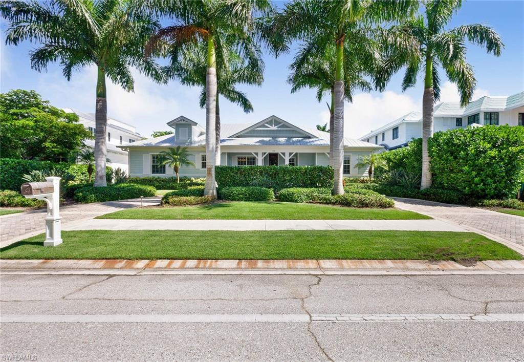 150 Central Avenue Naples, FL 34102 - Photo 32 of 35 a front view of multi story residential apartment building with yard and green space